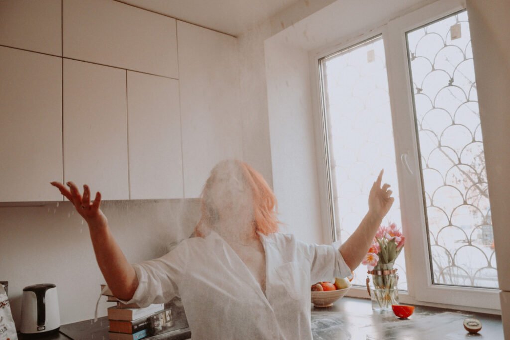 Woman throwing coconut flour in the air